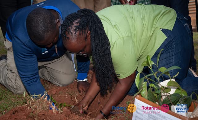Rotarians planting a tree seedling during 10 Days of Double Impact