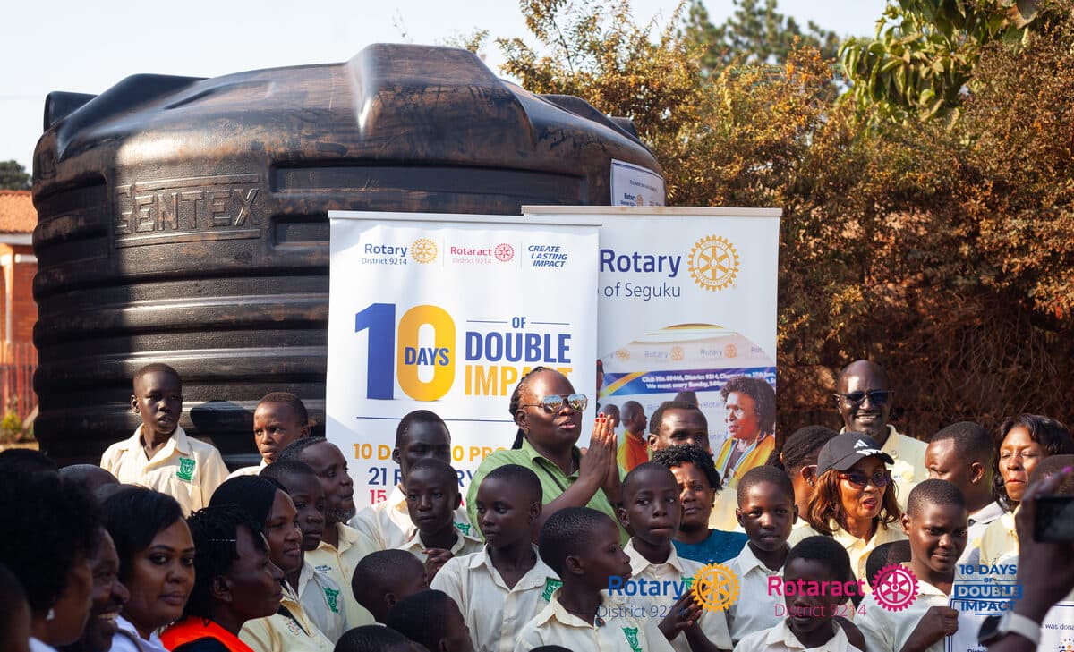 Pupils of St. Gyavira Primary School Lweza at the water tank donated under 10 Days of Double Impact